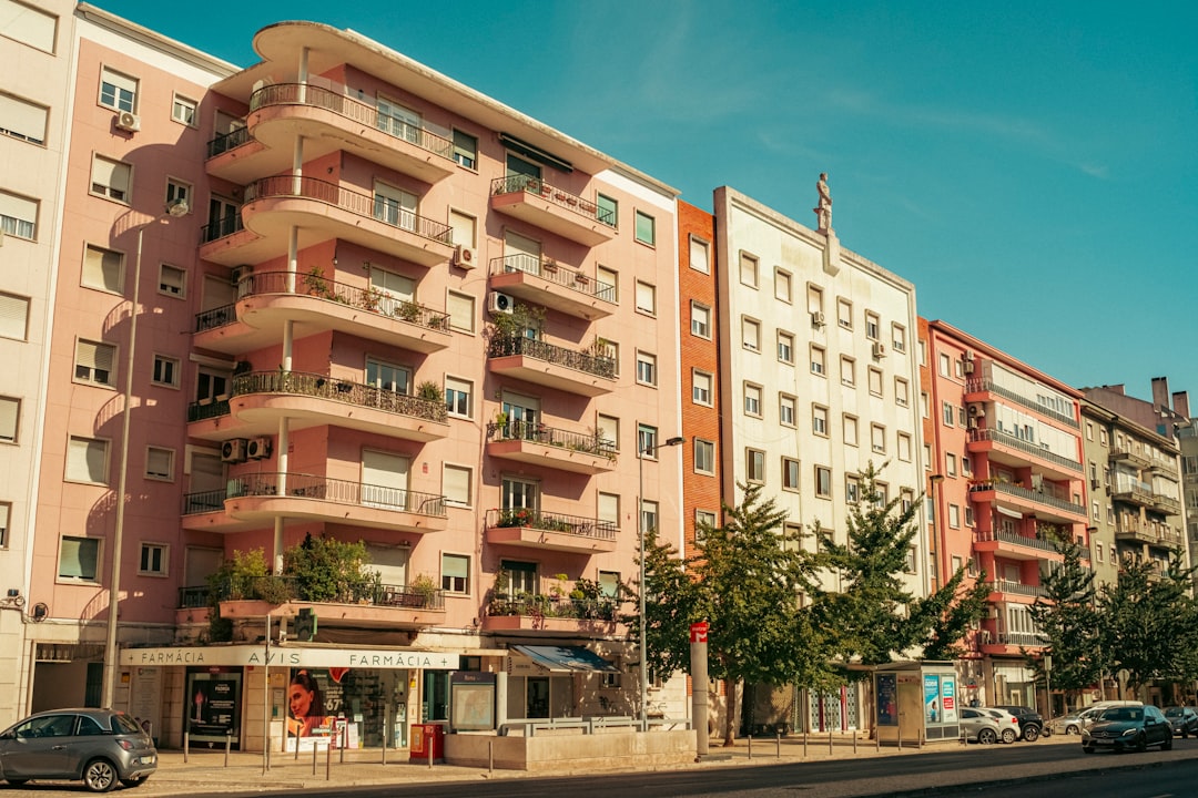 Row of apartment buildings with balconies and shops.