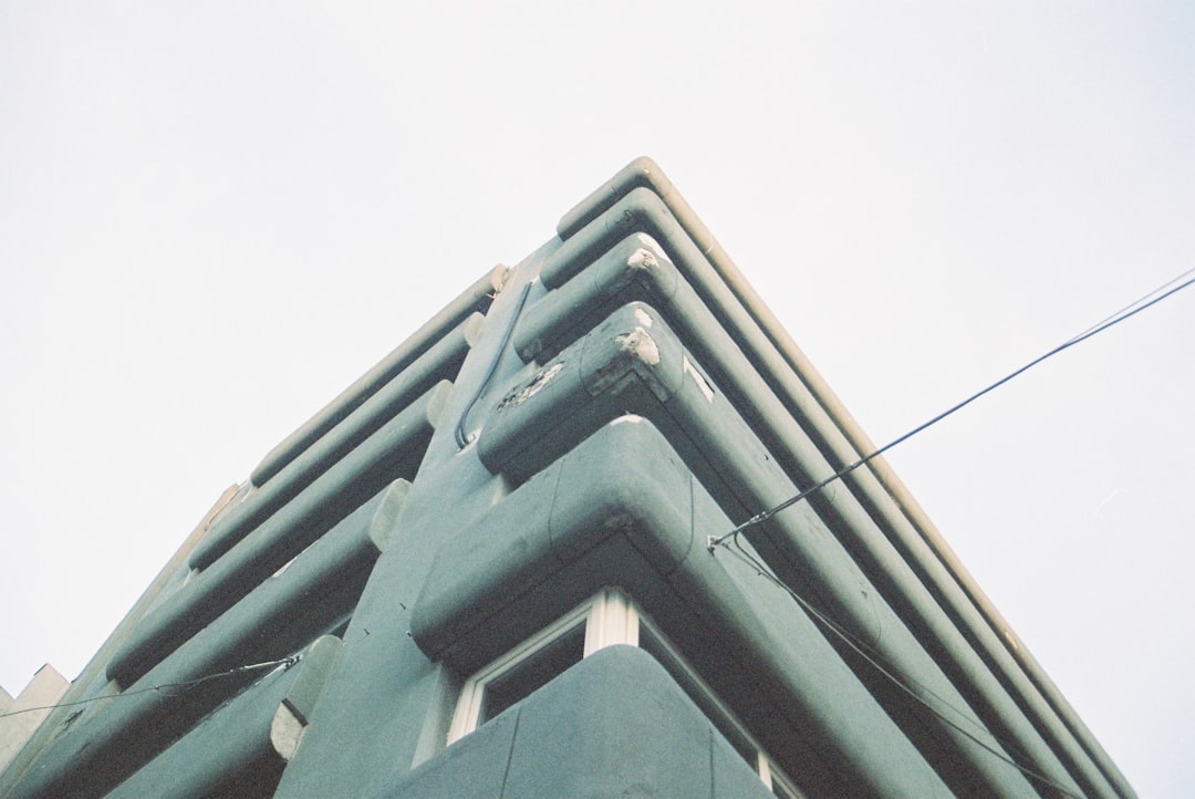 A teal building with layered horizontal lines