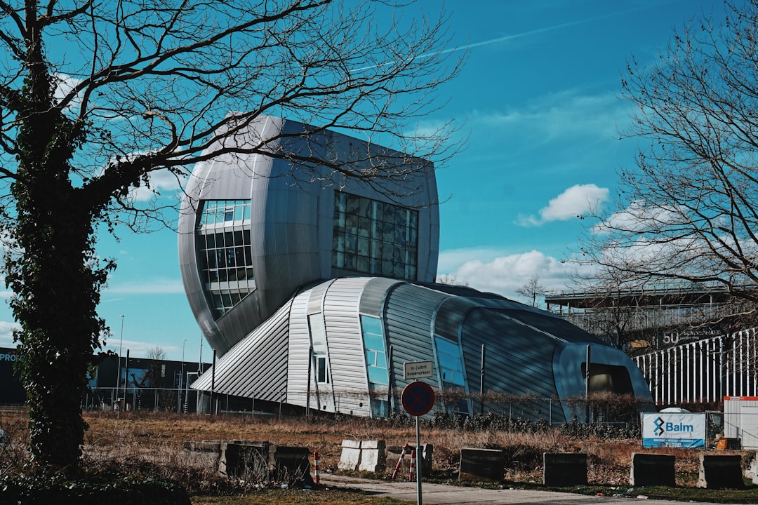 bare tree near glass building
